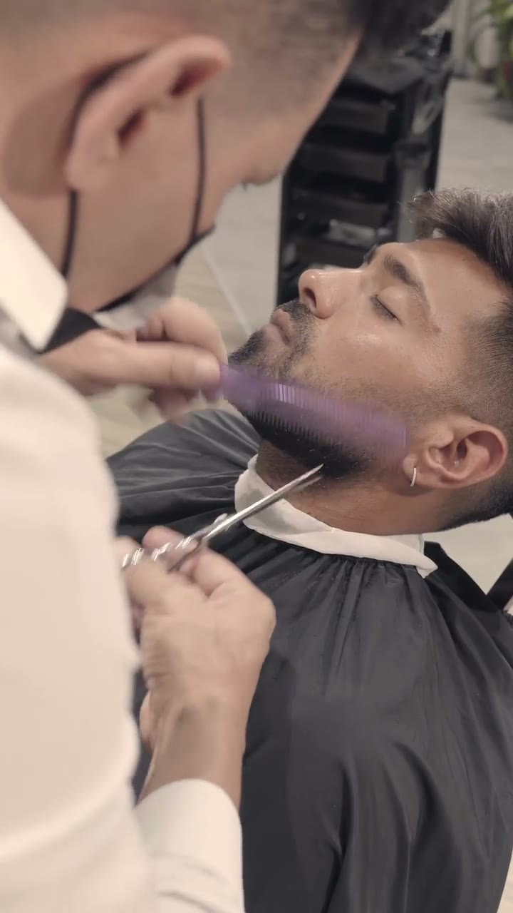Barber at work during a grooming ritual at Scissors and Razors