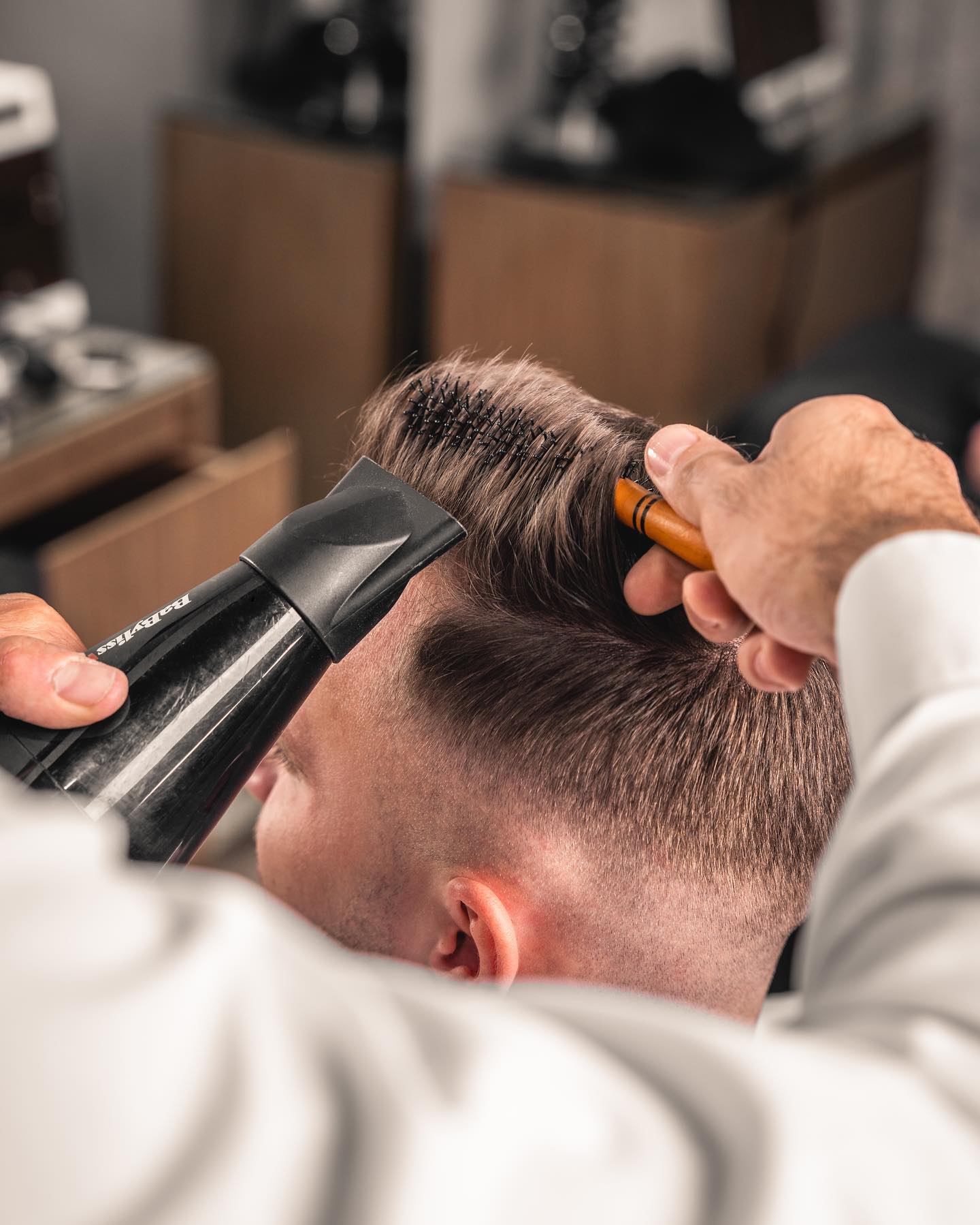 Hair styling with dryer and round brush at Scissors and Razors Dubai