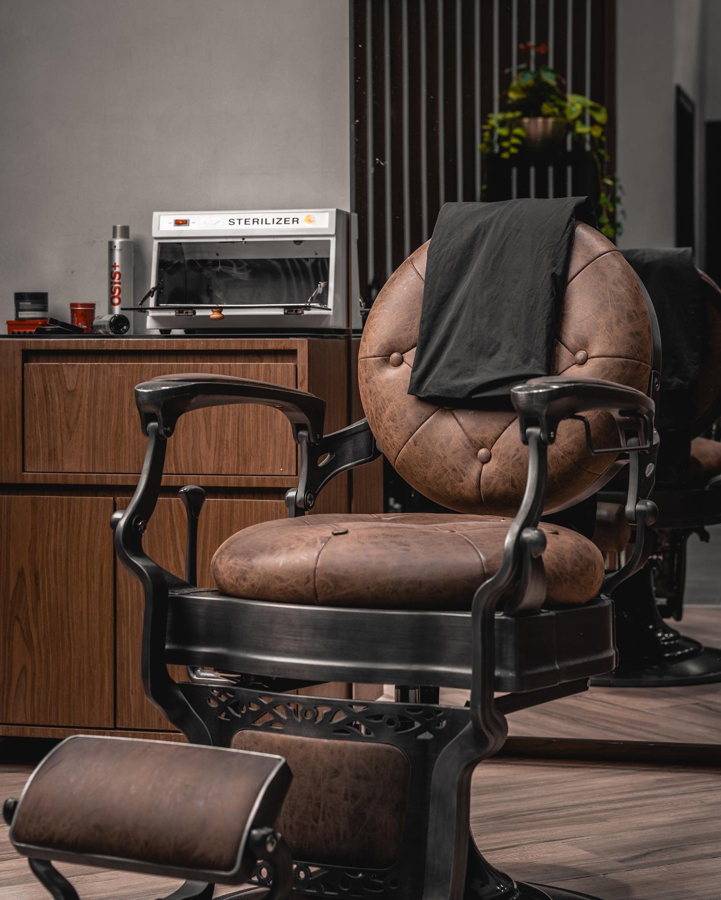 Leather barber chair and grooming workstation inside Scissors and Razors