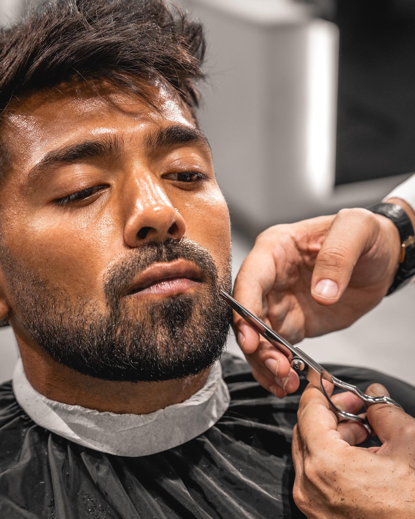 Extreme close-up of precision beard trimming with scissors