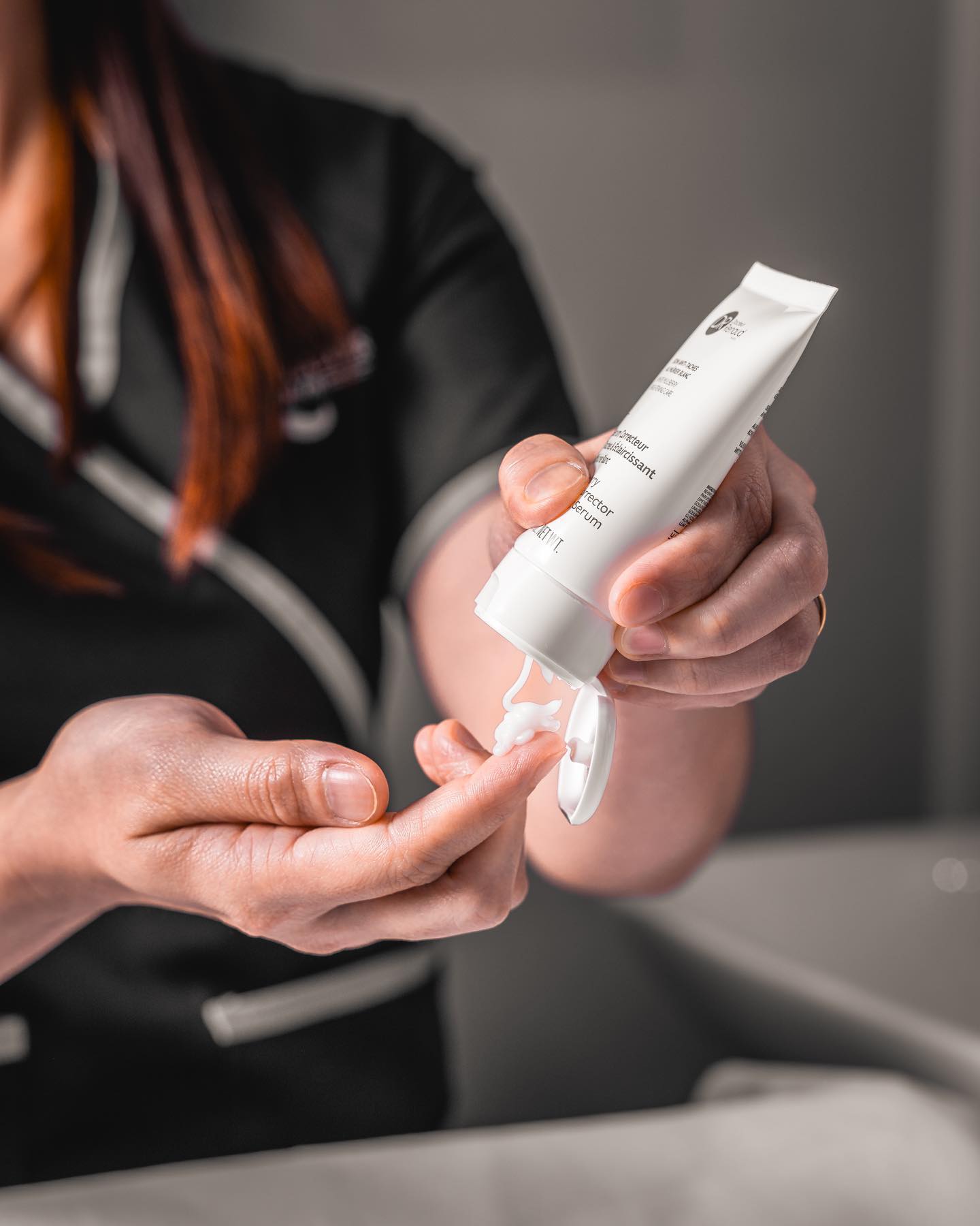 Barber dispensing skincare product before a grooming treatment